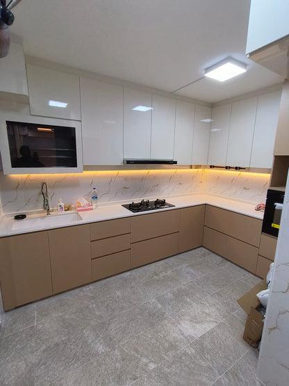 Modern kitchen with white cabinets, marble countertop, and tiled floor.