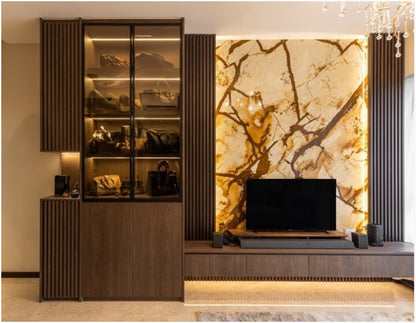 A brown wooden TV console with a marble-like backsplash in a room with various decor items.